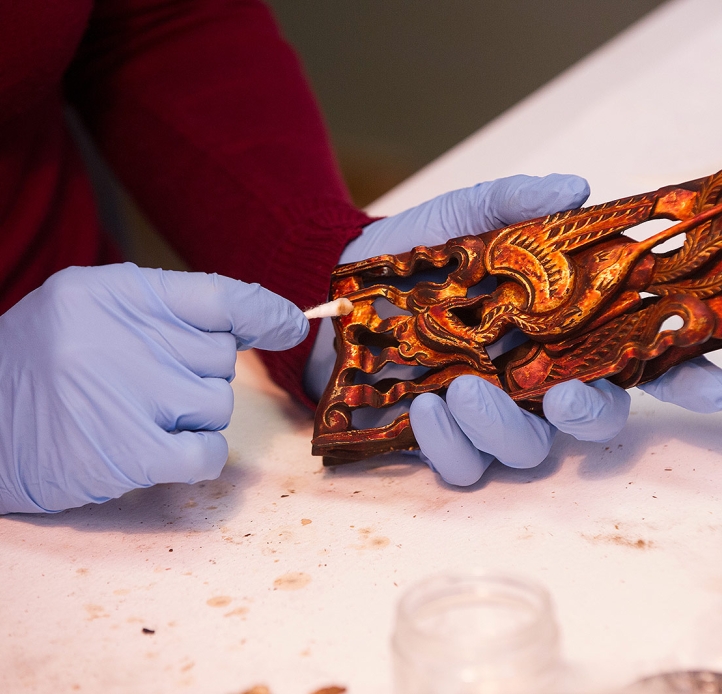 Student cleaning an object