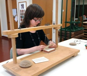 A student binding a book