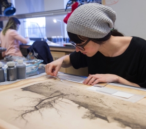 Student working on a paper object