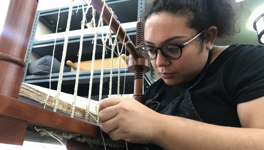 Nicole Alvarado making a book weaving the text block together